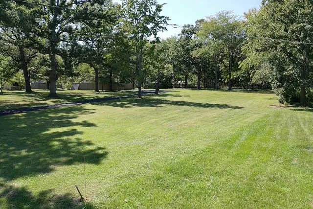 a view of a swimming pool with a yard