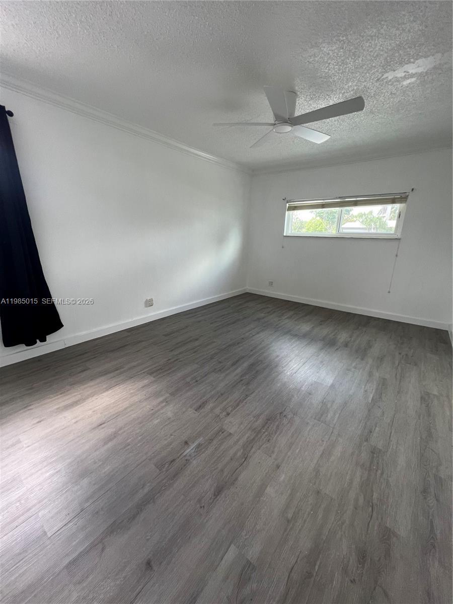 5730 Southwest 55th Street Davie, FL 33314 - Photo 11 of 34 an empty room with wooden floor and windows