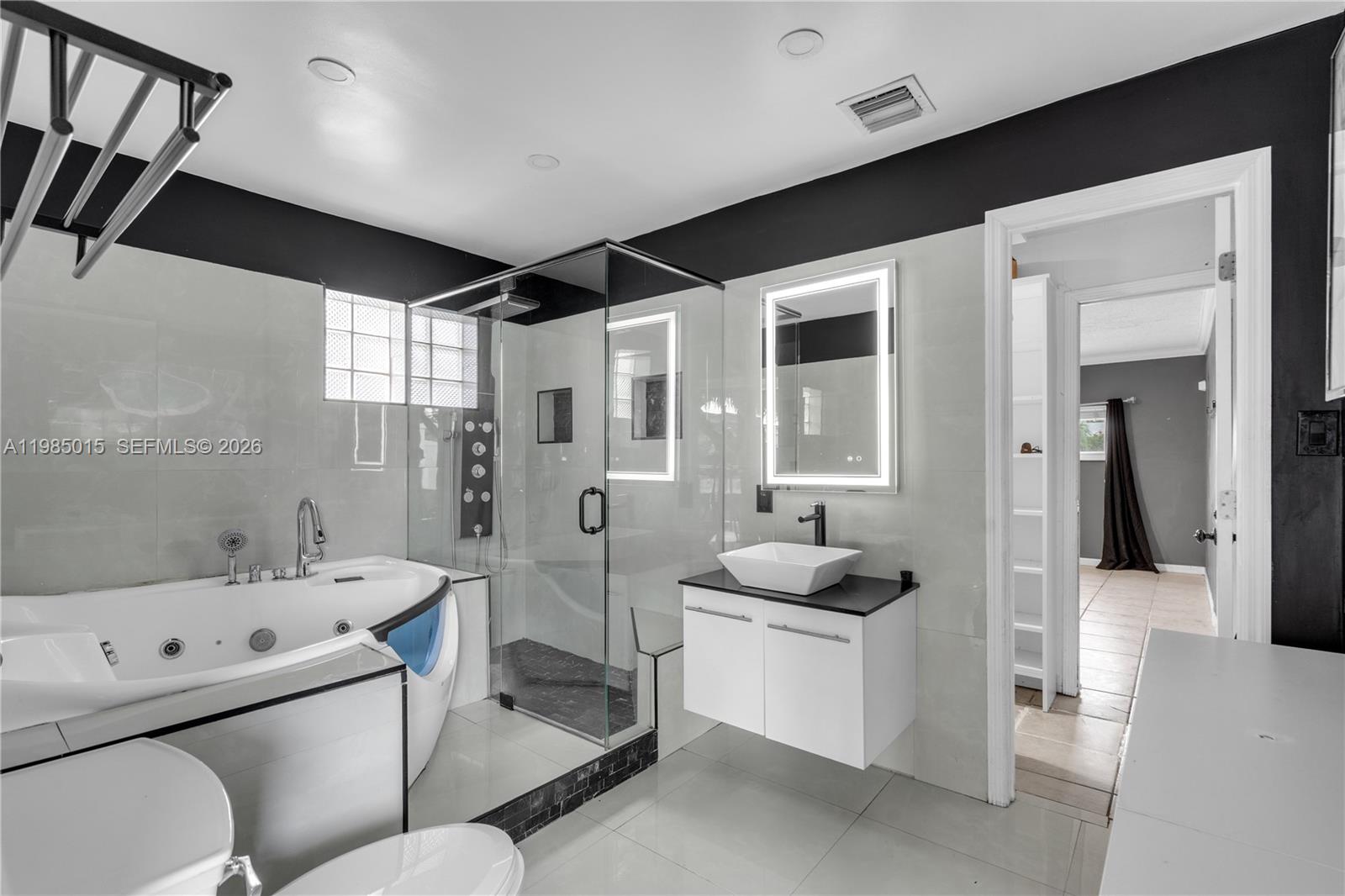 5730 Southwest 55th Street Davie, FL 33314 - Photo 14 of 34 a bathroom with a granite countertop sink mirror bathtub and toilet