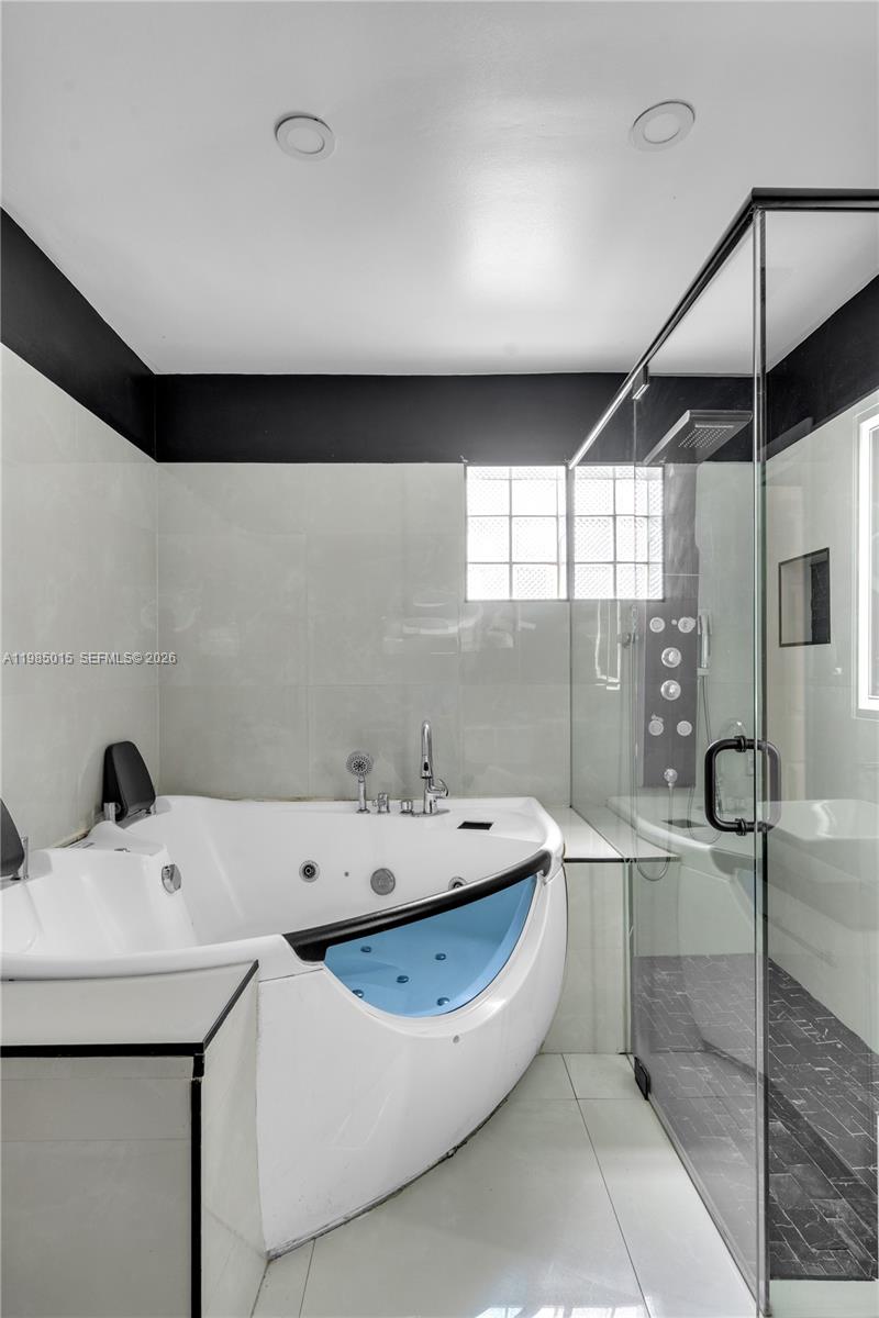 5730 Southwest 55th Street Davie, FL 33314 - Photo 15 of 34 a bathroom with a bathtub and a sink
