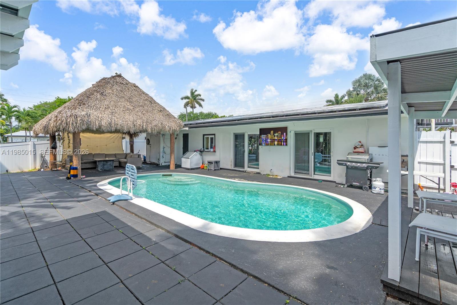 5730 Southwest 55th Street Davie, FL 33314 - Photo 18 of 34 a view of swimming pool with outdoor seating and a garden