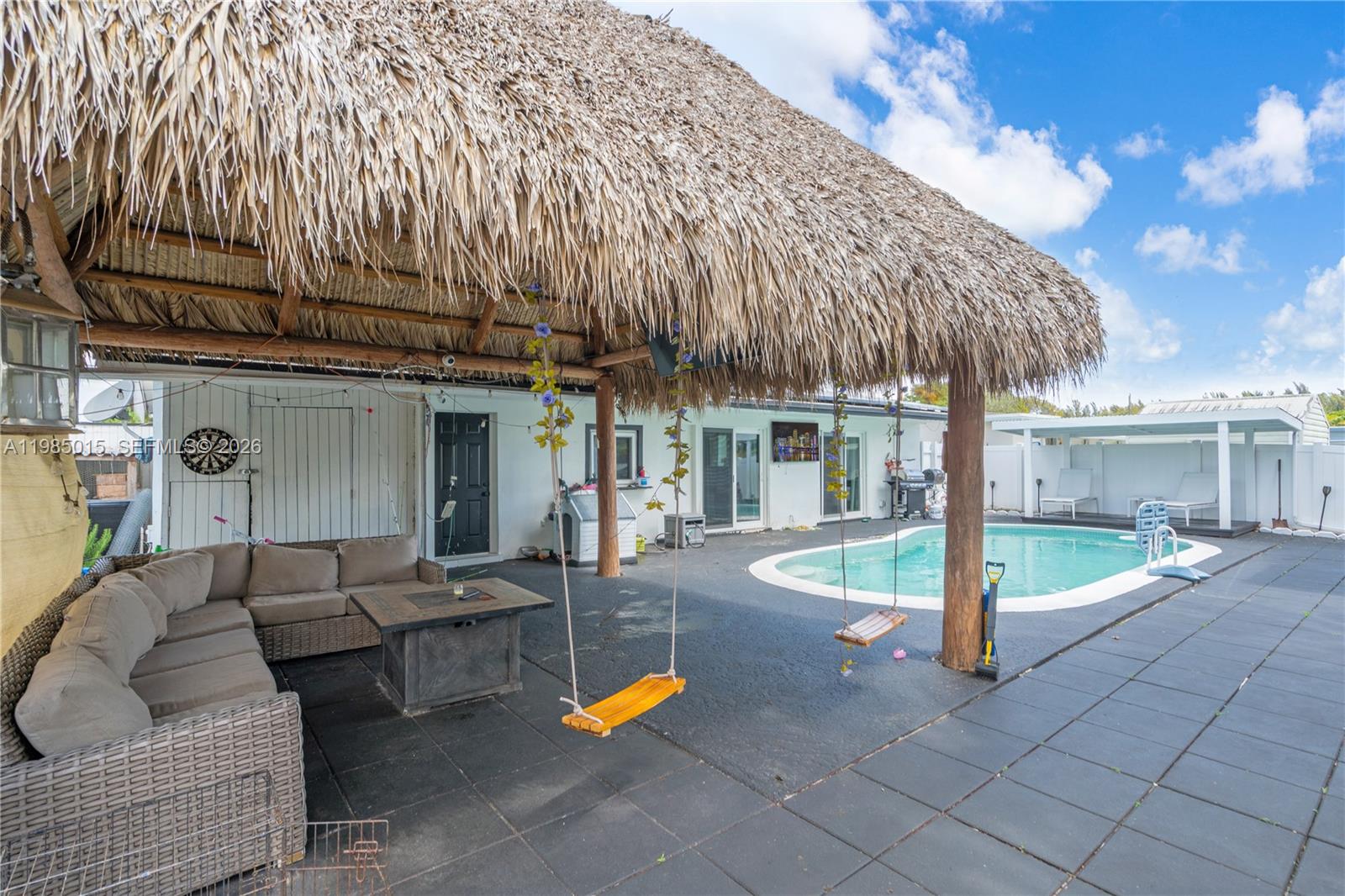 5730 Southwest 55th Street Davie, FL 33314 - Photo 24 of 34 a view of a white building with couches and wooden fence