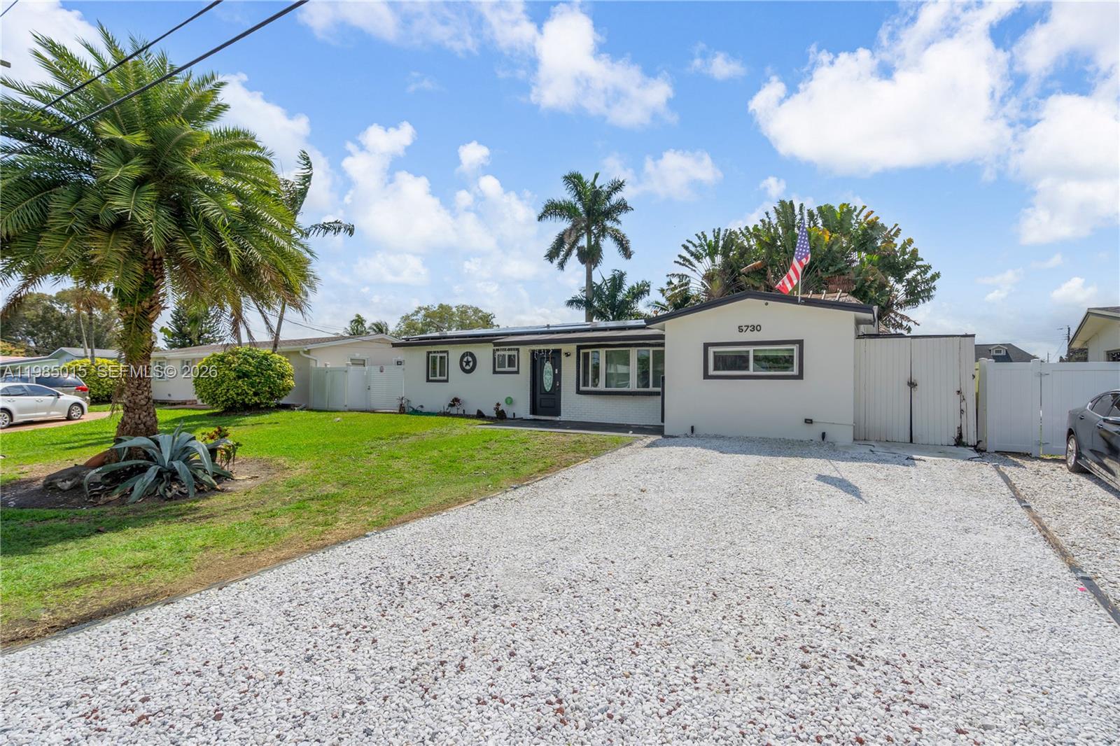 5730 Southwest 55th Street Davie, FL 33314 - Photo 3 of 34 a front view of a house with garden and a tree