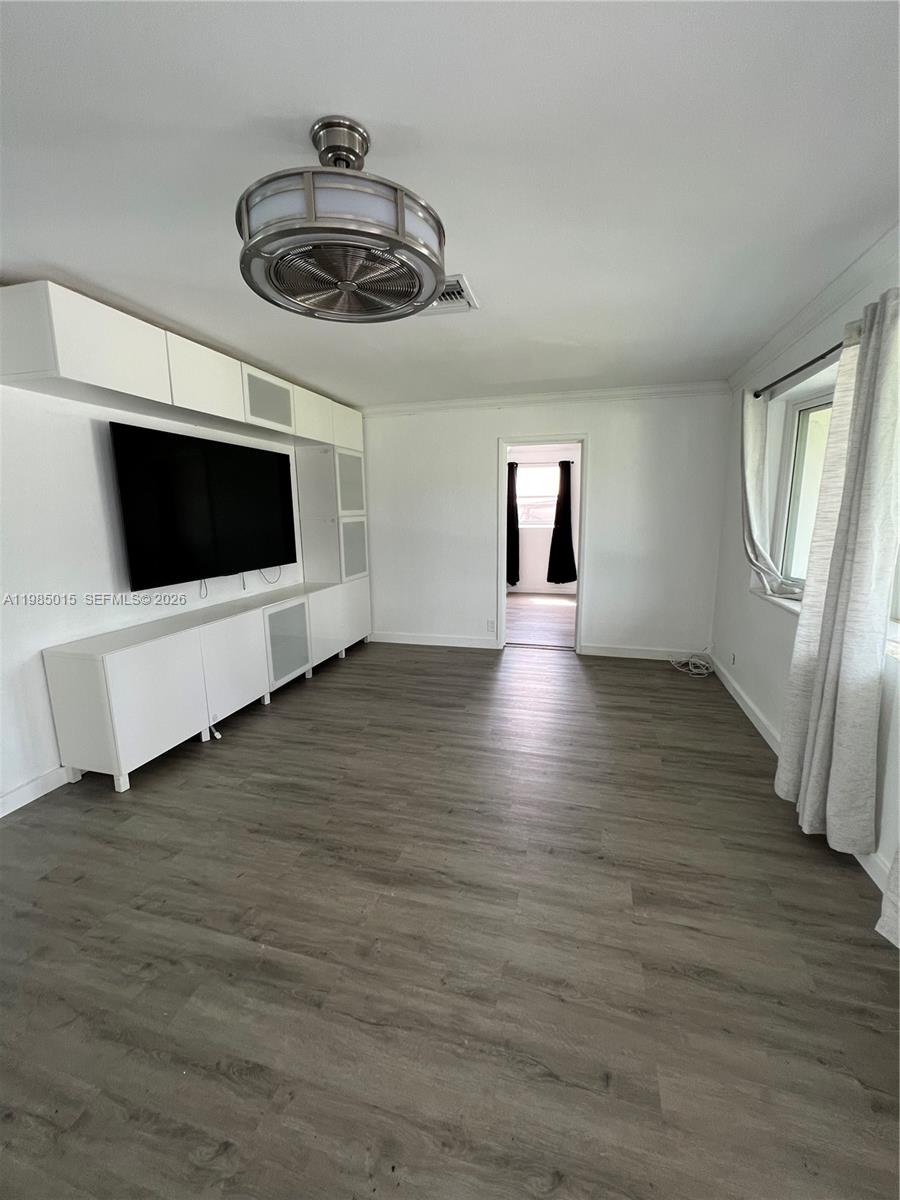 5730 Southwest 55th Street Davie, FL 33314 - Photo 5 of 34 a view of a livingroom with wooden floor and a ceiling fan