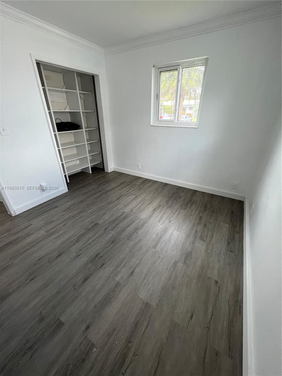 5730 Southwest 55th Street Davie, FL 33314 - Photo 9 of 34 wooden floor in an empty room with a window