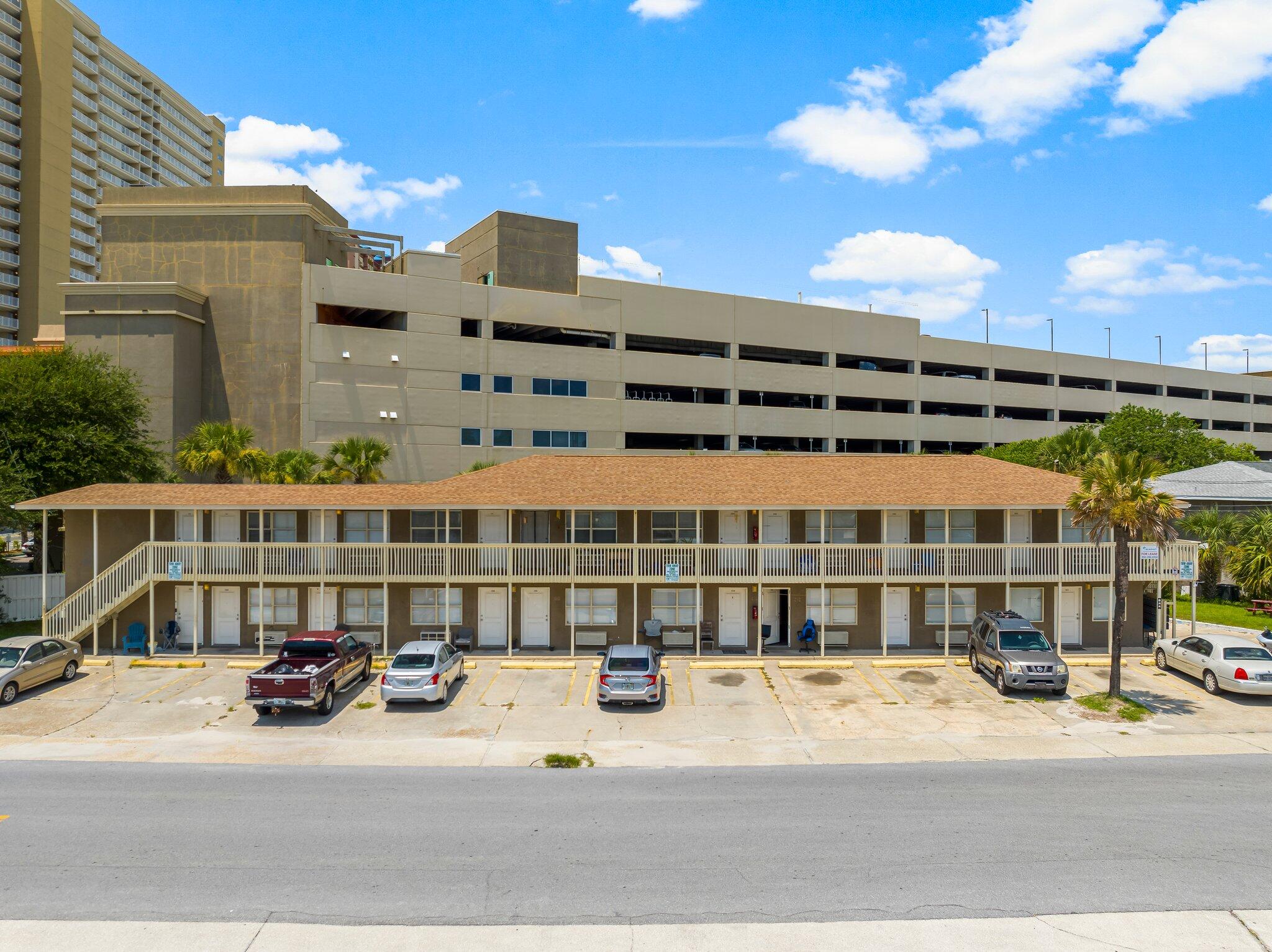 a view of a building with car parked