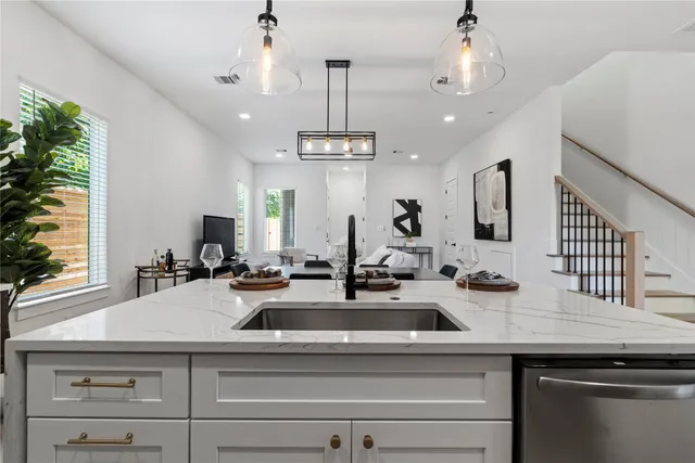 a kitchen with sink and white cabinets