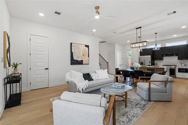 a living room with furniture a rug and a flat screen tv