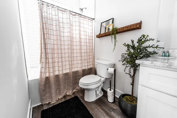 a bathroom with a toilet and a shower