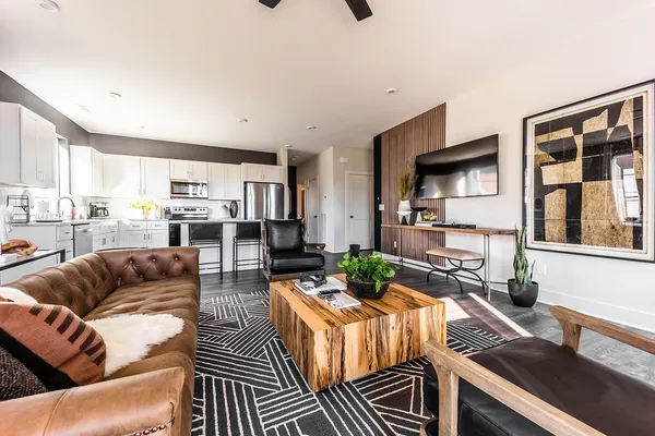 a living room with furniture a rug and a chandelier