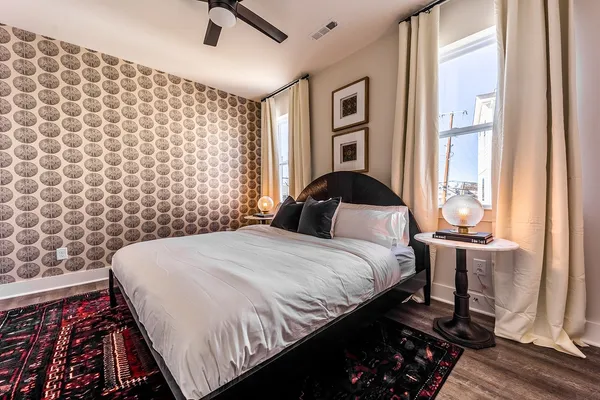 a bedroom with a bed and wooden floor
