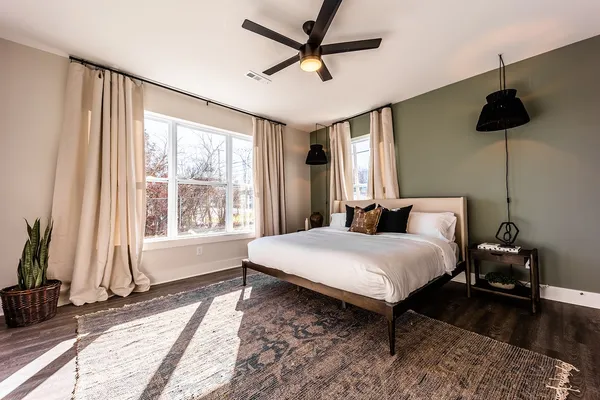 a bedroom with a bed and a chandelier