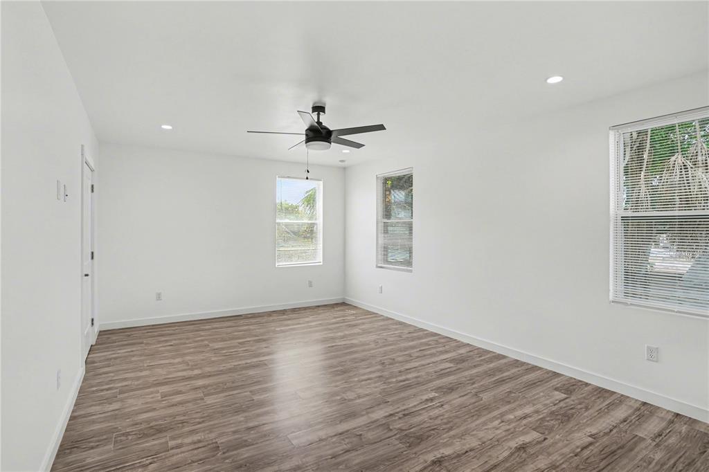 2328 West Spruce Street, Unit A Tampa, FL 33607 - Photo 12 of 15 wooden floor in an empty room with a window