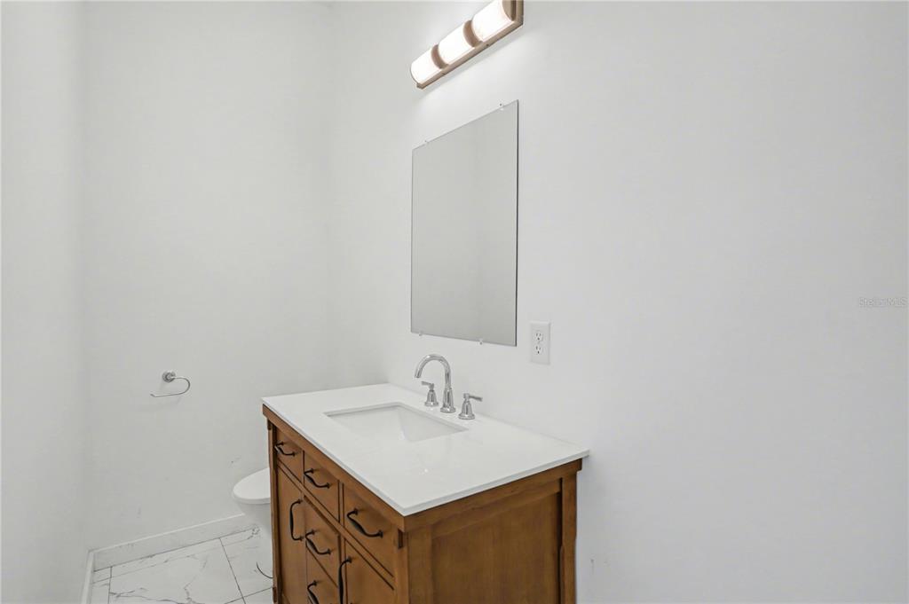 2328 West Spruce Street, Unit A Tampa, FL 33607 - Photo 6 of 15 a bathroom with a sink and a mirror