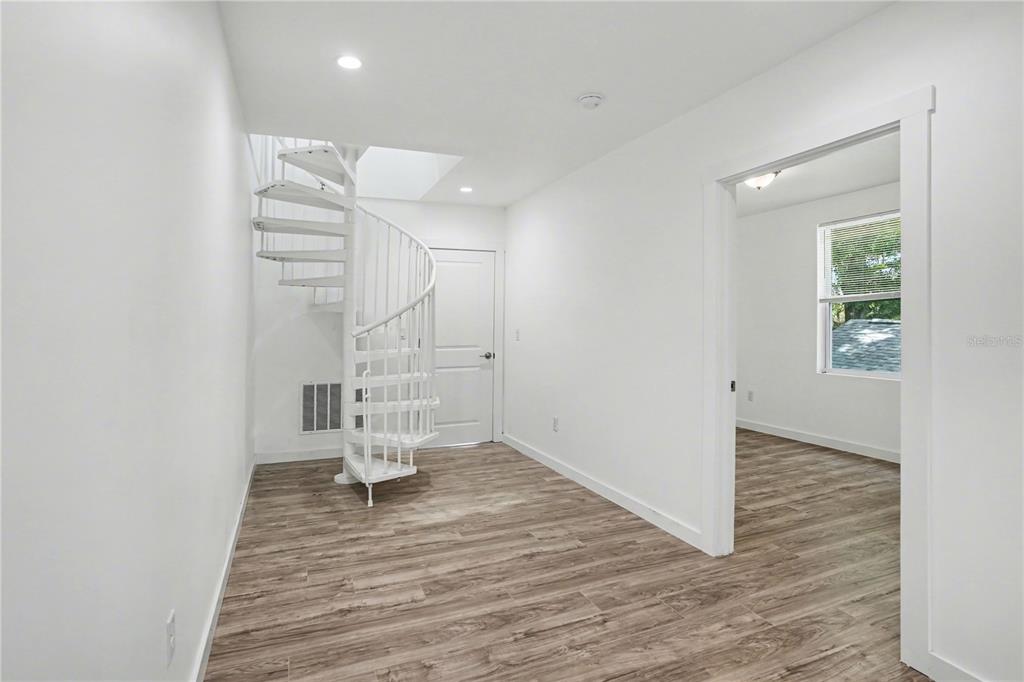 2328 West Spruce Street, Unit A Tampa, FL 33607 - Photo 7 of 15 wooden floor in an empty room with a window