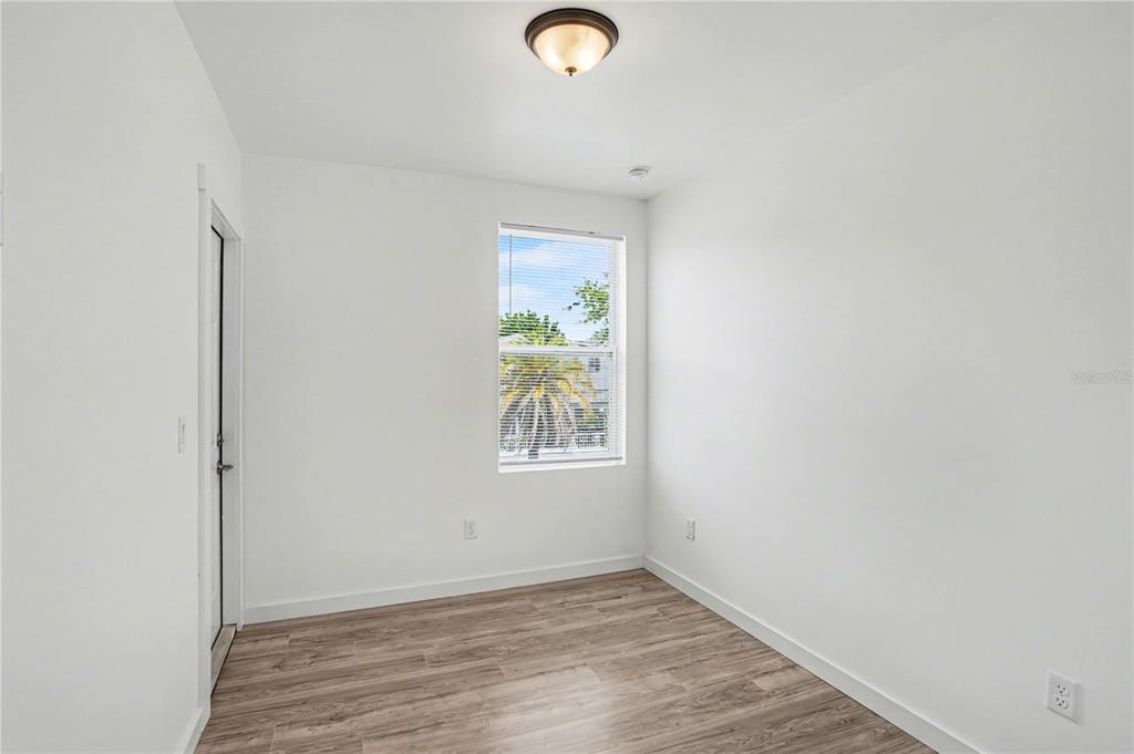 2328 West Spruce Street, Unit A Tampa, FL 33607 - Photo 8 of 15 a view of room with window and wooden floor