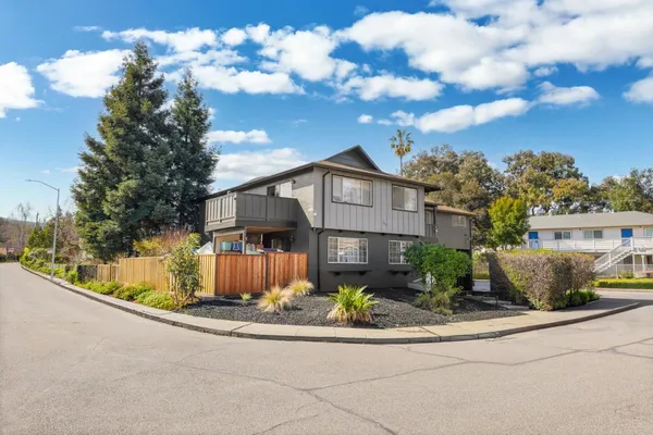 a front view of a house with a garden