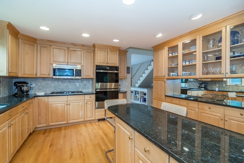 7 Kendall Road Lexington, MA 02421 - Photo 5 of 16 a kitchen with stainless steel appliances granite countertop a sink and cabinets