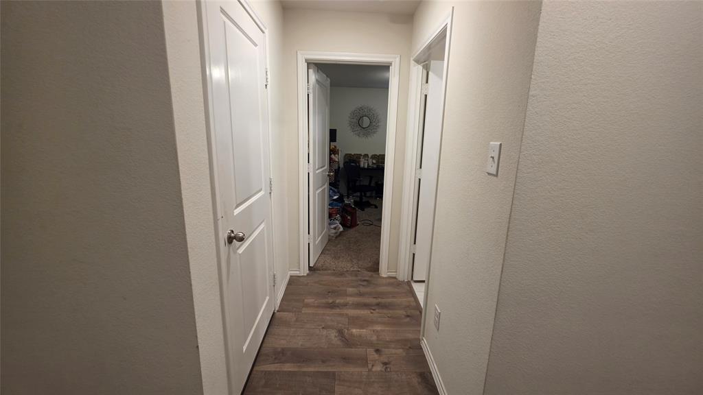 409 Samuel Street Denton, TX 76207 - Photo 15 of 40 a view of a hallway with wooden shelves