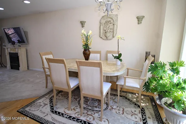 a dining room with furniture a rug and wooden floor