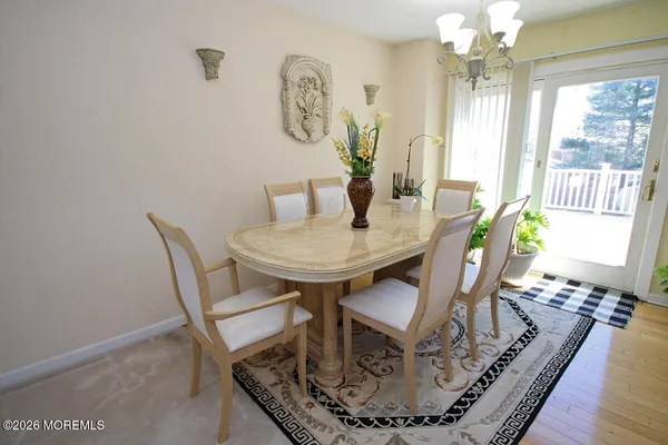a dining room with furniture a rug and wooden floor