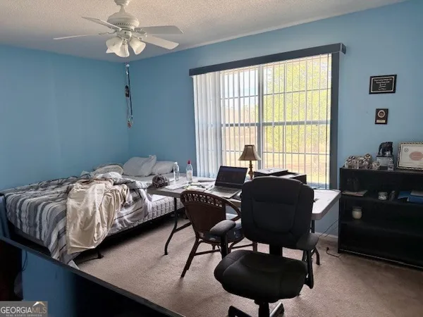 a bedroom with bed and a window