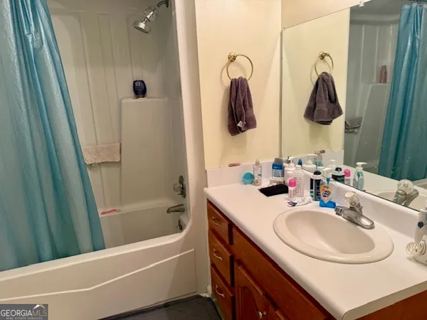 a bathroom with a sink tub and a mirror