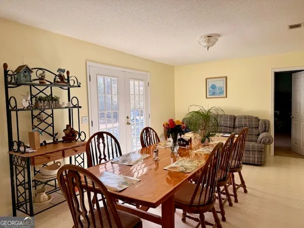 a view of a dining room with furniture and chandelier