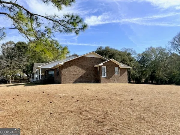 a front view of a house with a yard covered with snow in front of house