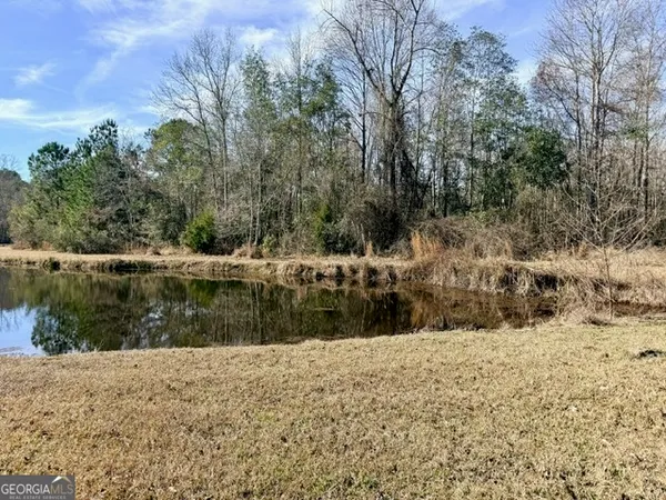 a view of yard covered with snow in front of house