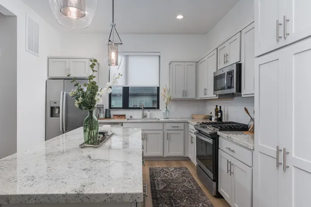 a kitchen with a sink stove and refrigerator