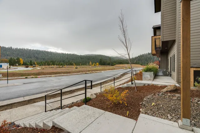 a view of a terrace with yard and mountain view in back