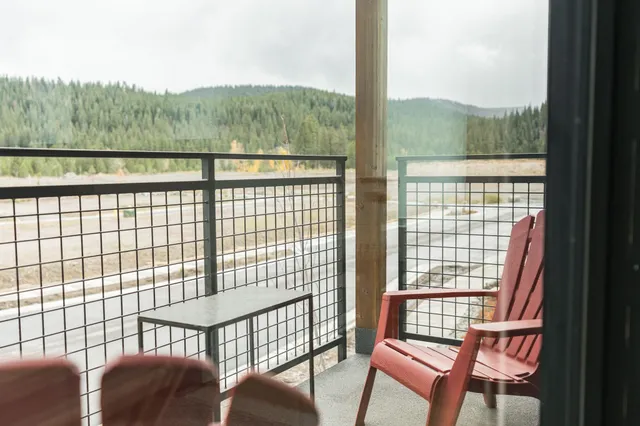 a view of a city from a balcony with furniture