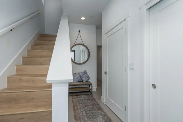 a view of entryway and hall with wooden floor