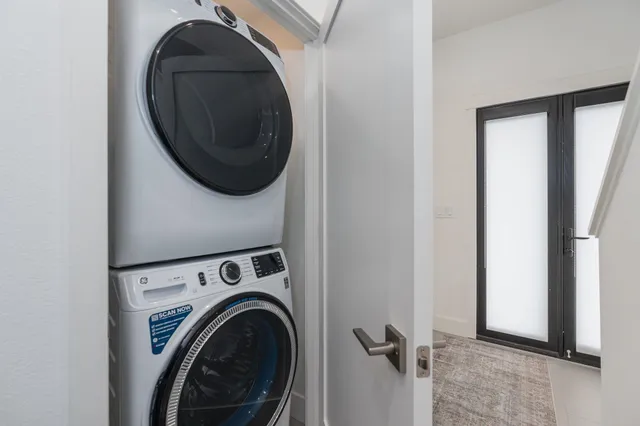 a view of a hallway with washer and dryer