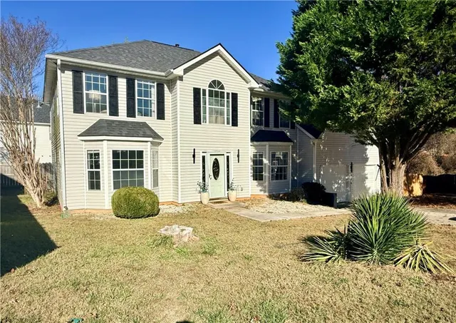 a front view of a house with a yard