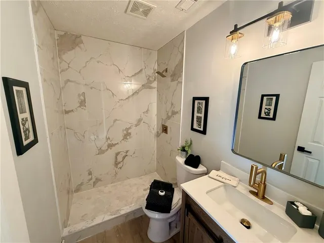 a bathroom with a sink toilet and shower