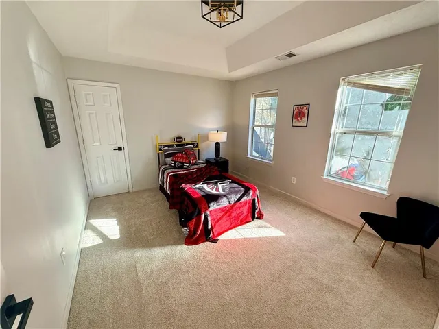 a bedroom with furniture and a window