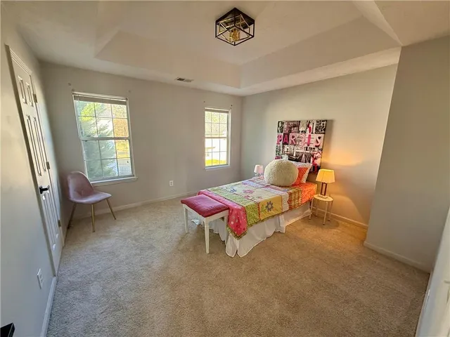 a bedroom with a bed and a table in it