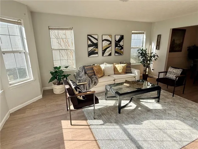 a living room with furniture potted plant and a window