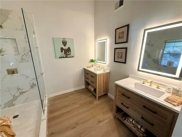 a bathroom with a sink mirror and a bath tub