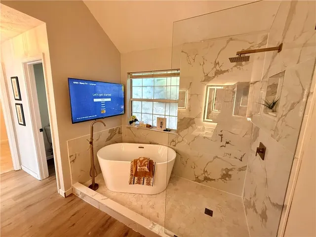 a bathroom with a tub sink and shower curtain