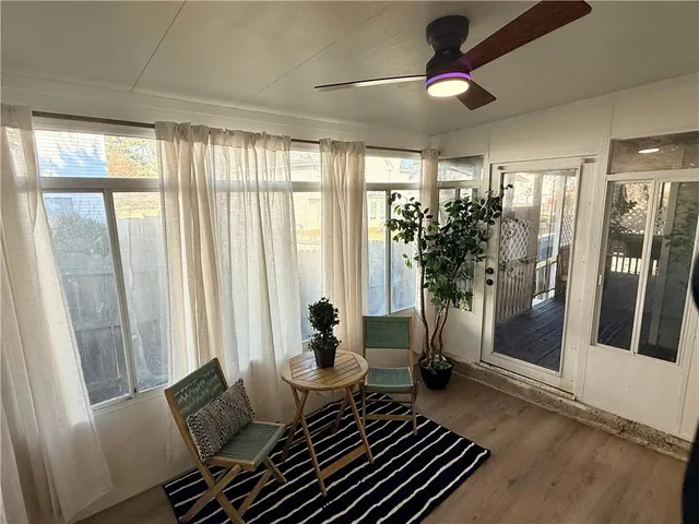 a living room with furniture and a floor to ceiling window