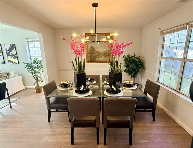 a view of a dining room with furniture and window