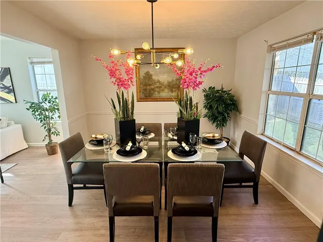 a view of a dining room with furniture window and wooden floor