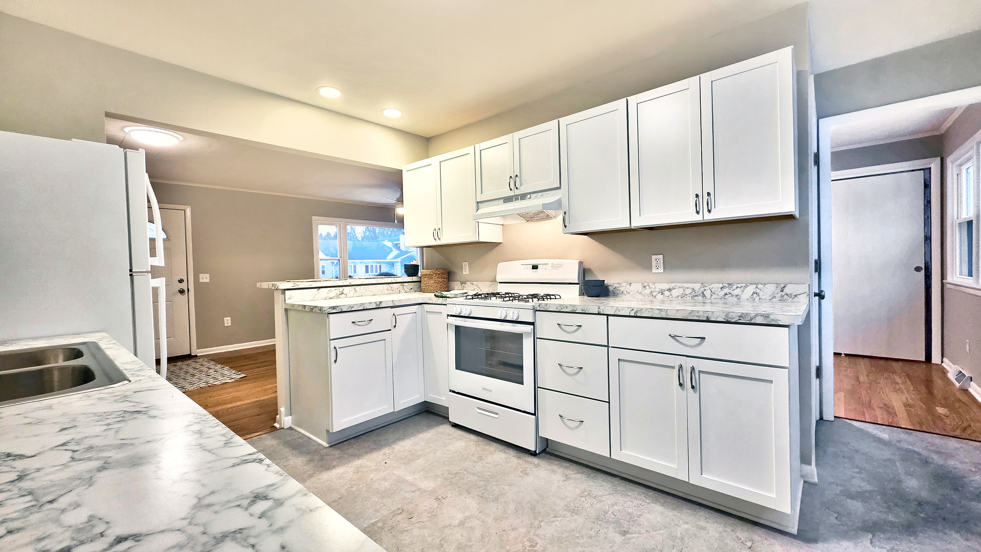1509 Pine Street McHenry, IL 60051 - Photo 11 of 17 a kitchen with granite countertop white cabinets and white appliances