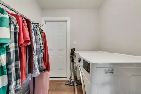 a view of walk in closet with clothes