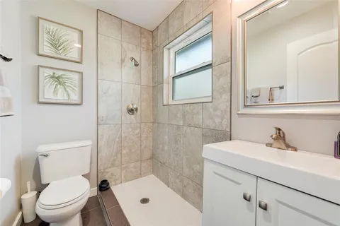 a bathroom with a sink mirror toilet and vanity
