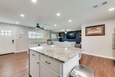 a kitchen with granite countertop sink and microwave