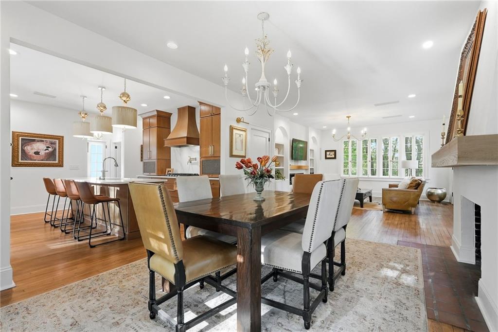 3944 Bakerstown Road Gibsonia, PA 15044 - Photo 21 of 50 a view of a dining room and livingroom with furniture wooden floor a rug a flat screen tv a rug and a chandelier